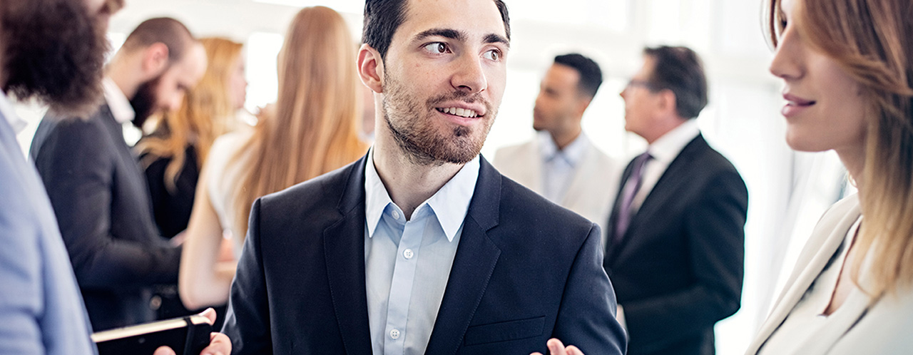 A man is looking at a woman at a formal reception 