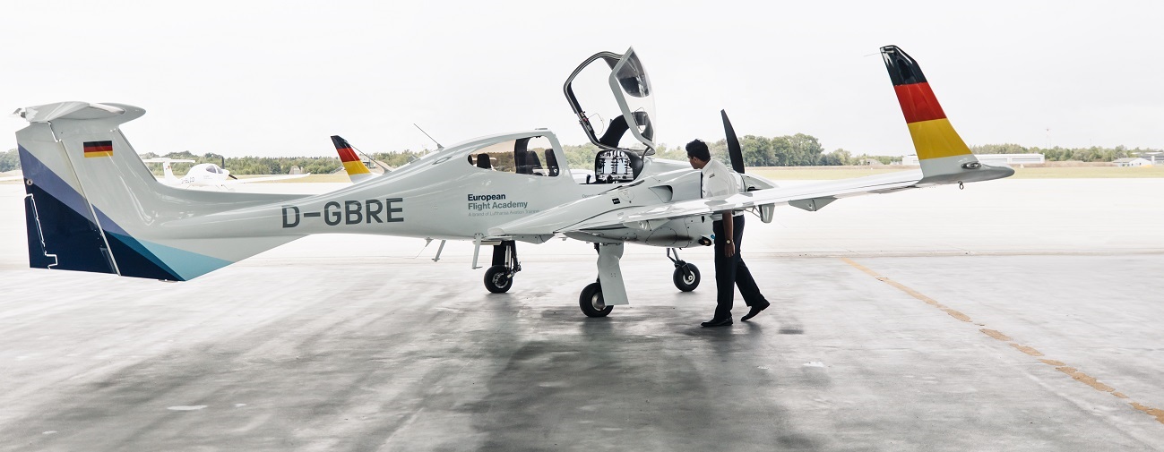 A flight student is inspecting a DA42.