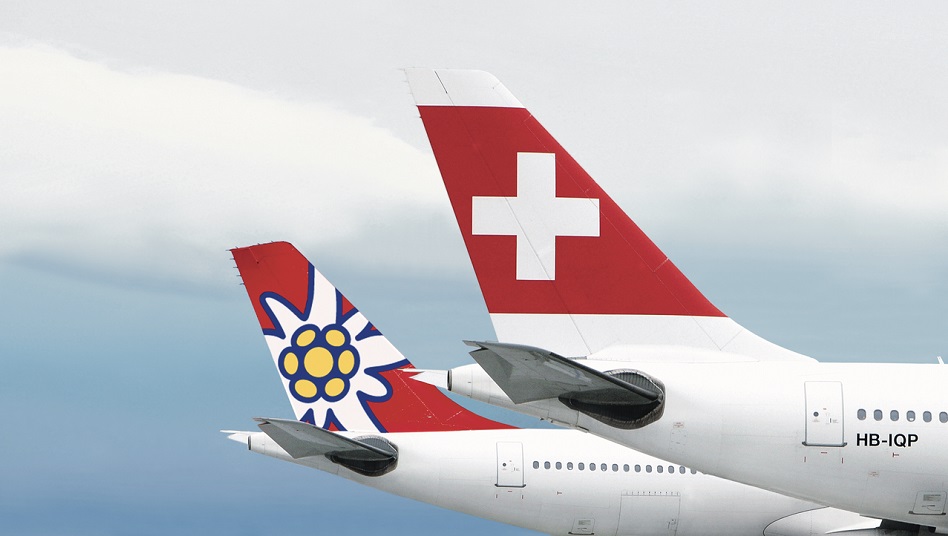 Two aircraft from the airlines SWISS and Edelweiss are parked one behind the other.
